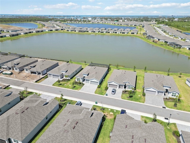bird's eye view featuring a water view and a residential view
