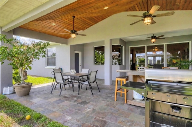 view of patio with outdoor dining space and a ceiling fan