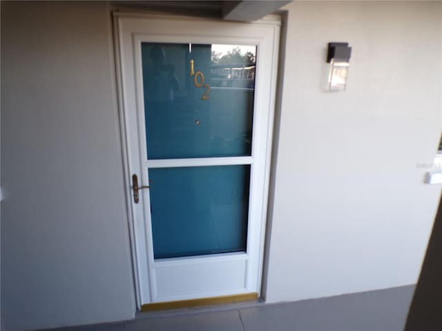 entrance to property with stucco siding