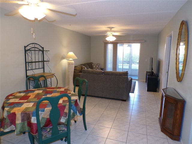 dining space featuring ceiling fan and light tile patterned flooring