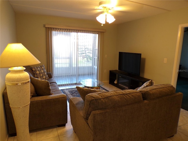 living room featuring a ceiling fan and light tile patterned floors