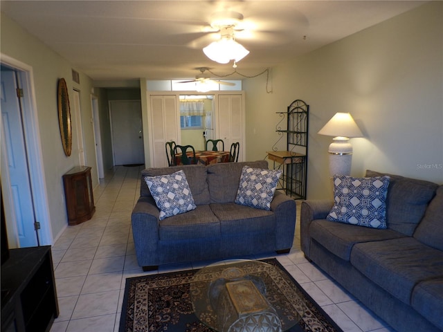 living room featuring light tile patterned flooring, ceiling fan, and visible vents