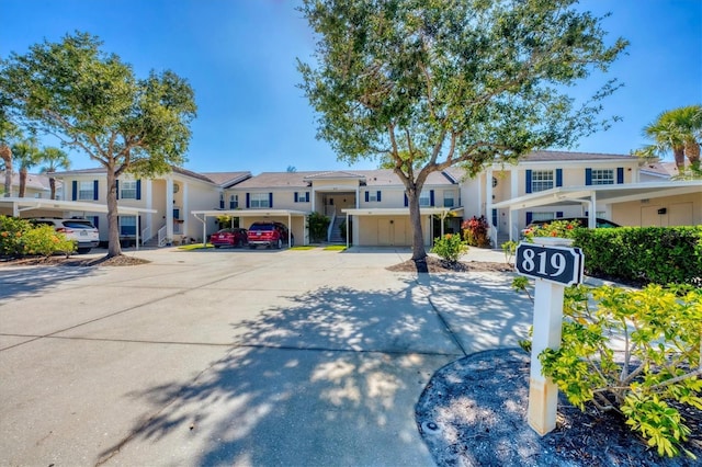 819 Montrose Dr Unit 102, Venice, FL 34293 - view of front of house with covered parking, a residential view, and stucco siding