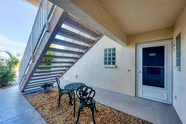 819 Montrose Dr Unit 102, Venice, FL 34293 - doorway to property with stucco siding