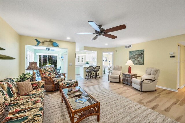 819 Montrose Dr Unit 102, Venice, FL 34293 - living room featuring ceiling fan, visible vents, plenty of natural light, and light wood finished floors