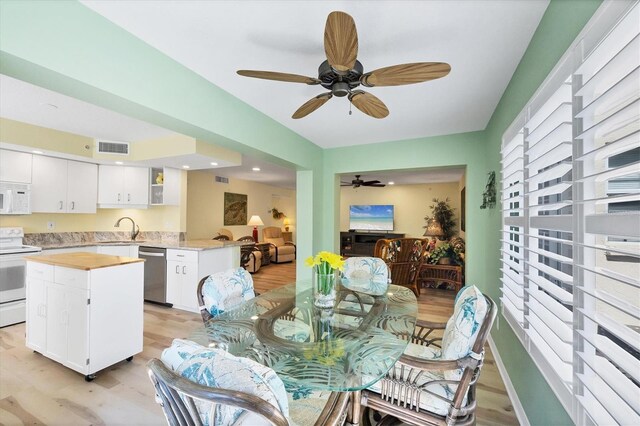 819 Montrose Dr Unit 102, Venice, FL 34293 - dining space with a ceiling fan, visible vents, and light wood-style flooring
