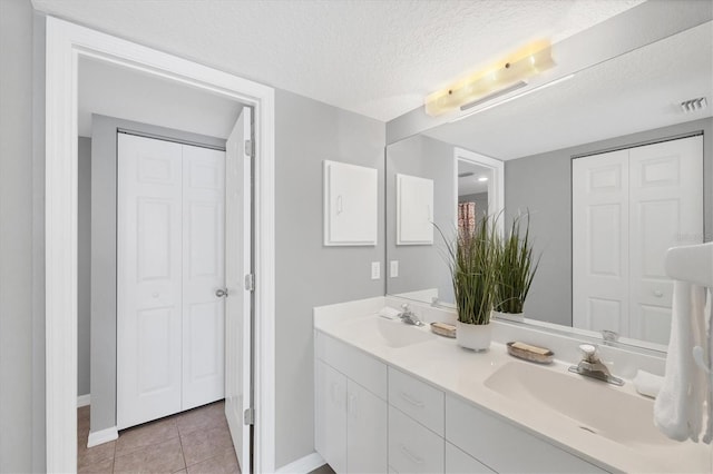 819 Montrose Dr Unit 102, Venice, FL 34293 - bathroom featuring a closet, a sink, baseboards, and a textured ceiling