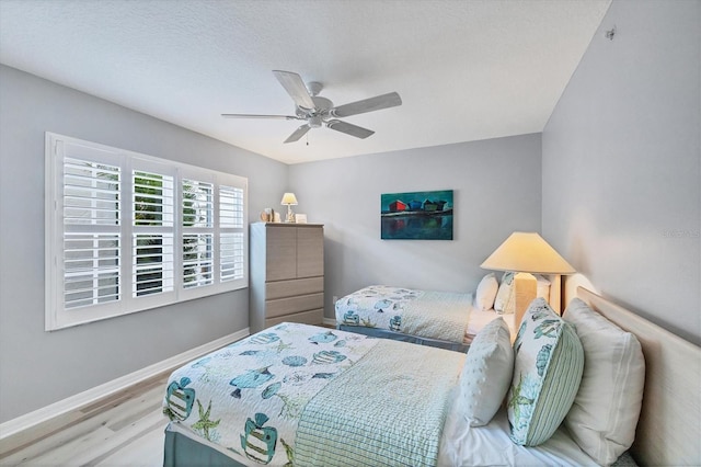 819 Montrose Dr Unit 102, Venice, FL 34293 - bedroom with baseboards, a ceiling fan, and wood finished floors