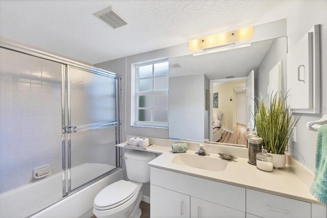 819 Montrose Dr Unit 102, Venice, FL 34293 - bathroom with toilet, a textured ceiling, visible vents, and vanity