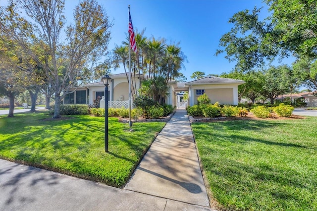 819 Montrose Dr Unit 102, Venice, FL 34293 - view of front of house with a front yard and stucco siding