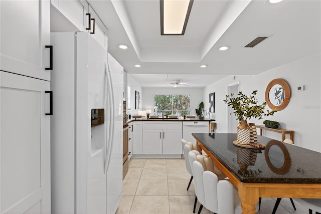 5031 N Beach Rd Unit 118, Englewood, FL 34223 - kitchen featuring white appliances, recessed lighting, dark countertops, white cabinets, and a raised ceiling