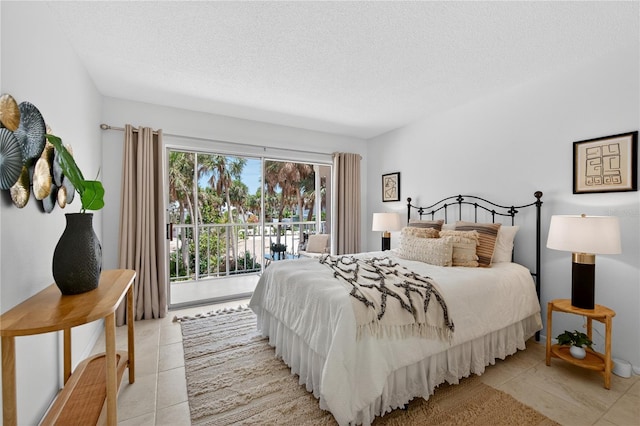 5031 N Beach Rd Unit 118, Englewood, FL 34223 - bedroom with light tile patterned floors, access to exterior, and a textured ceiling