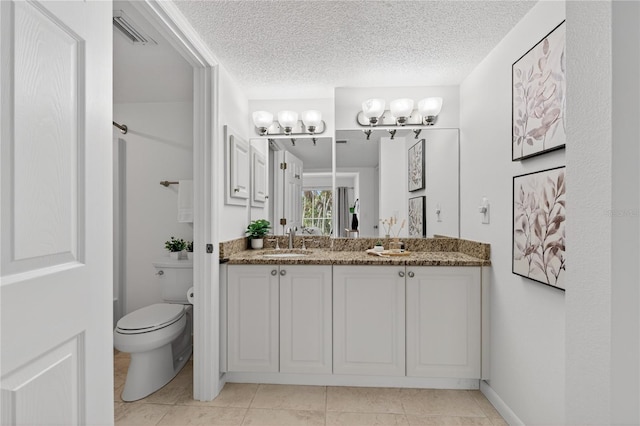 5031 N Beach Rd Unit 118, Englewood, FL 34223 - bathroom with double vanity, a textured ceiling, and tile patterned flooring