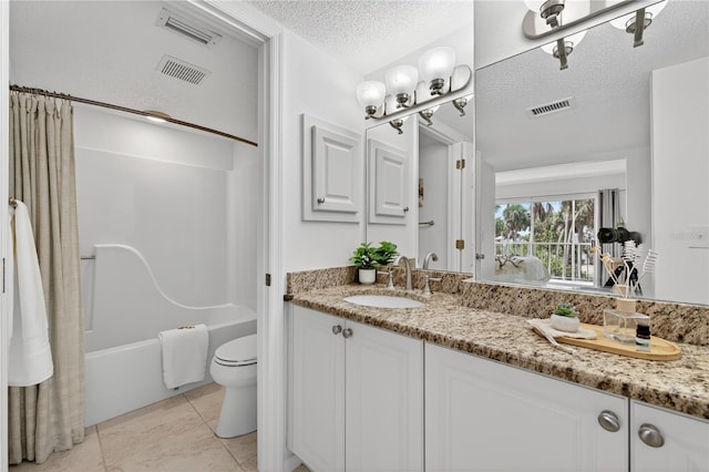 5031 N Beach Rd Unit 118, Englewood, FL 34223 - bathroom featuring vanity, shower / bath combo with shower curtain, a textured ceiling, and tile patterned floors