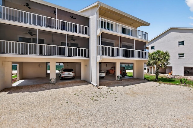 5031 N Beach Rd Unit 118, Englewood, FL 34223 - view of building exterior featuring a carport and dirt driveway