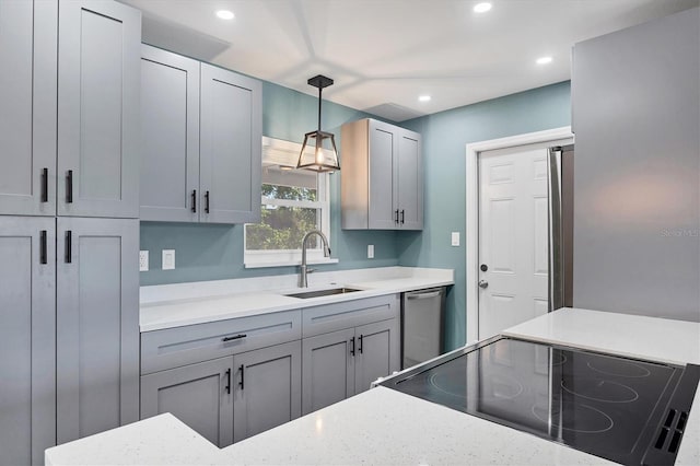kitchen featuring a sink, stove, recessed lighting, decorative light fixtures, and gray cabinetry
