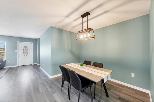 dining room featuring baseboards and wood finished floors