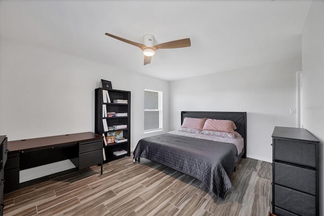 bedroom featuring baseboards, a ceiling fan, and wood finished floors