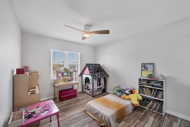 game room with baseboards and wood finish floors