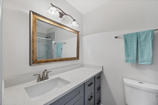 full bathroom with toilet, a shower stall, and vanity