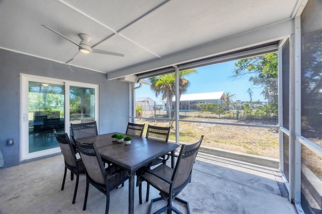 sunroom / solarium with ceiling fan and outdoor dining area