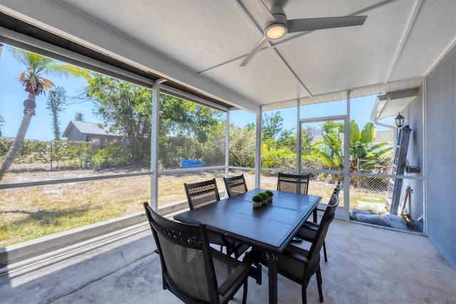 sunroom / solarium featuring ceiling fan and outdoor dining space