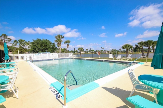 pool featuring fence and a patio area
