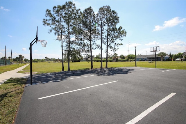 view of sport court with a lawn and community basketball court
