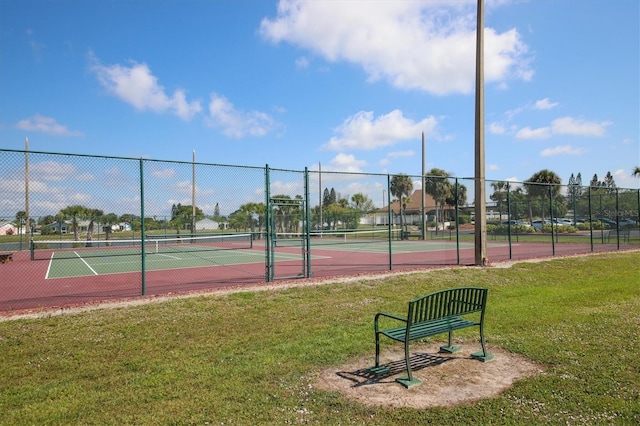 view of sport court with a yard and fence