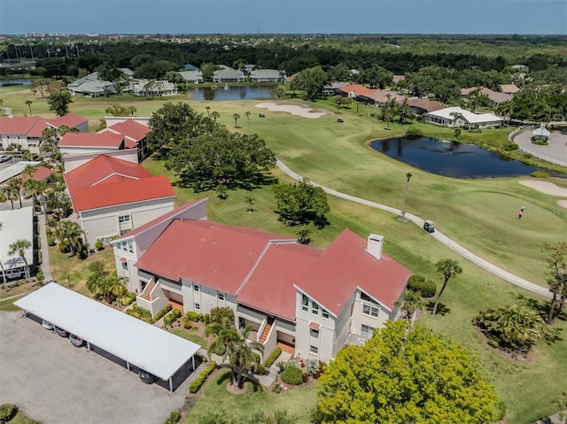aerial view with view of golf course, a water view, and a residential view