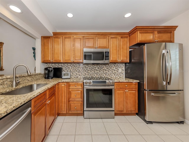 kitchen featuring a sink, stainless steel appliances, and brown cabinets