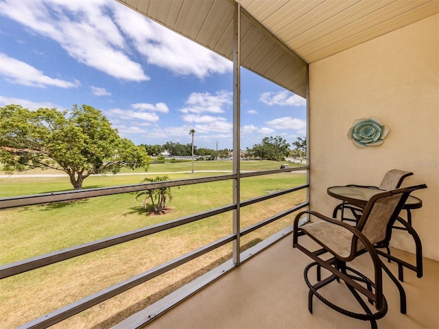 sunroom featuring golf course view