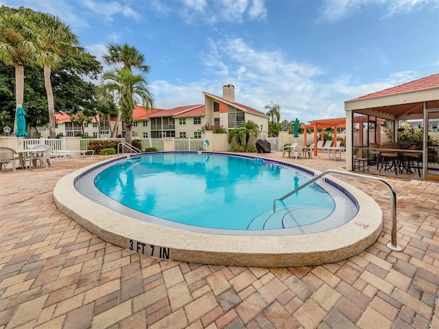pool featuring a gazebo, outdoor dining space, a patio, and fence