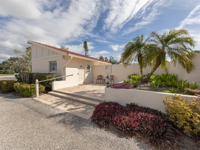 mediterranean / spanish home with stucco siding and fence