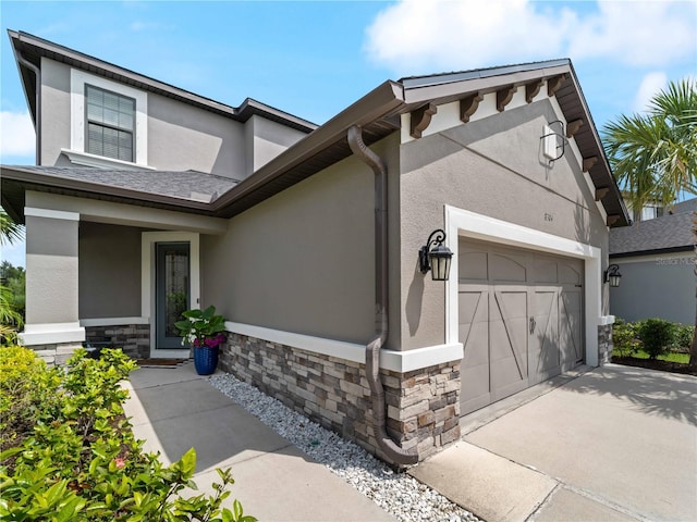 8304 Shooting Star Rd, Sarasota, FL 34241 - view of front of home with stone siding, stucco siding, a garage, and driveway