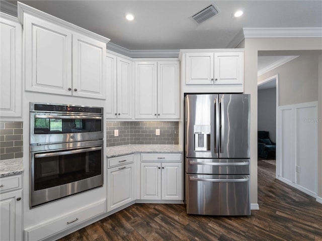 8304 Shooting Star Rd, Sarasota, FL 34241 - kitchen with stainless steel appliances, ornamental molding, white cabinetry, dark wood-style floors, and recessed lighting