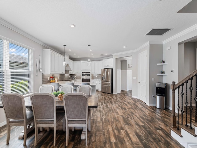 8304 Shooting Star Rd, Sarasota, FL 34241 - dining room with stairs, dark wood-style flooring, baseboards, ornamental molding, and recessed lighting