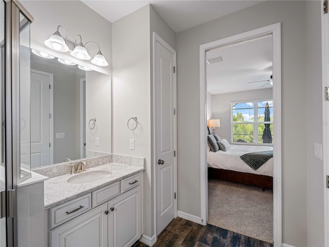 8304 Shooting Star Rd, Sarasota, FL 34241 - bathroom with wood finished floors, vanity, ensuite bath, ceiling fan, and baseboards