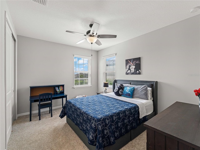 8304 Shooting Star Rd, Sarasota, FL 34241 - bedroom featuring light colored carpet, a ceiling fan, a textured ceiling, and baseboards