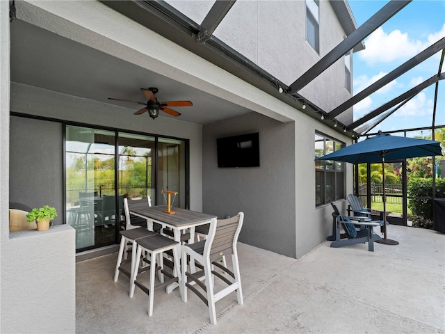8304 Shooting Star Rd, Sarasota, FL 34241 - view of patio featuring ceiling fan, glass enclosure, and outdoor dining space