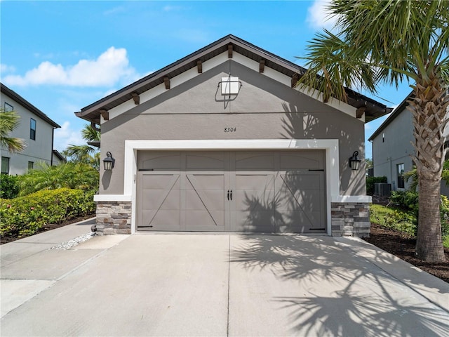 8304 Shooting Star Rd, Sarasota, FL 34241 - garage featuring driveway and central AC
