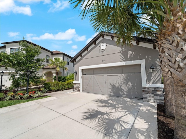 8304 Shooting Star Rd, Sarasota, FL 34241 - view of front facade featuring stucco siding, driveway, stone siding, and a garage
