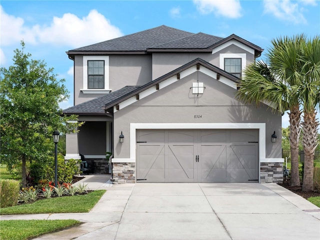 8304 Shooting Star Rd, Sarasota, FL 34241 - view of front of property with stone siding, stucco siding, driveway, and roof with shingles