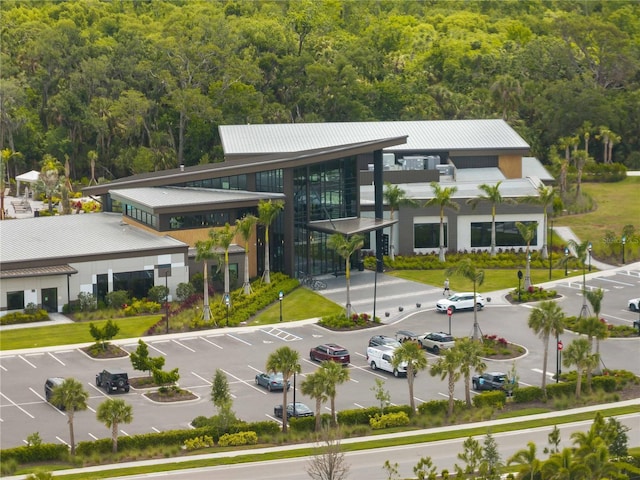8304 Shooting Star Rd, Sarasota, FL 34241 - view of building exterior featuring a view of trees and uncovered parking