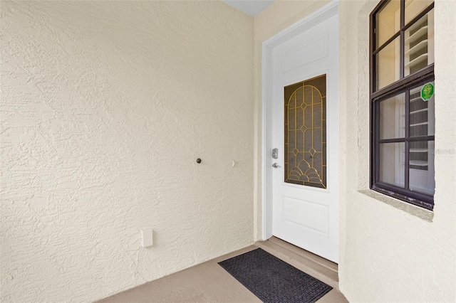 entrance to property featuring stucco siding