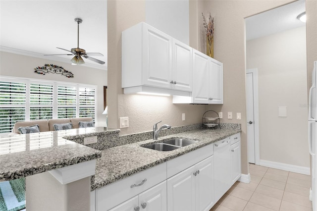 kitchen featuring light stone countertops, a sink, white appliances, a ceiling fan, and white cabinetry