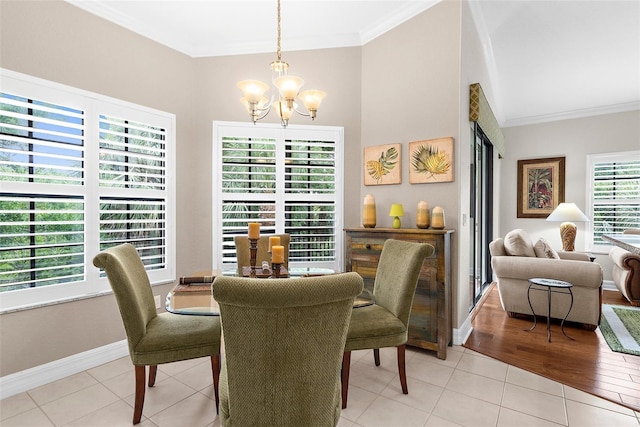 dining space with baseboards, ornamental molding, light tile patterned flooring, and a notable chandelier