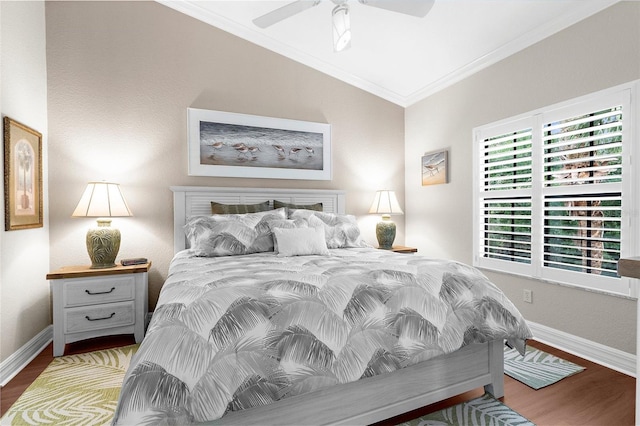 bedroom featuring crown molding, ceiling fan, baseboards, wood finished floors, and vaulted ceiling