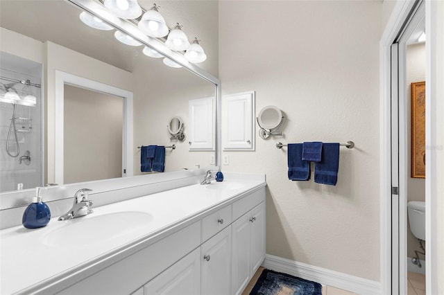 bathroom featuring double vanity, a sink, baseboards, and a shower