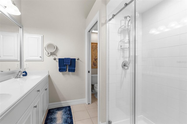 full bathroom featuring toilet, a shower stall, a sink, and tile patterned flooring